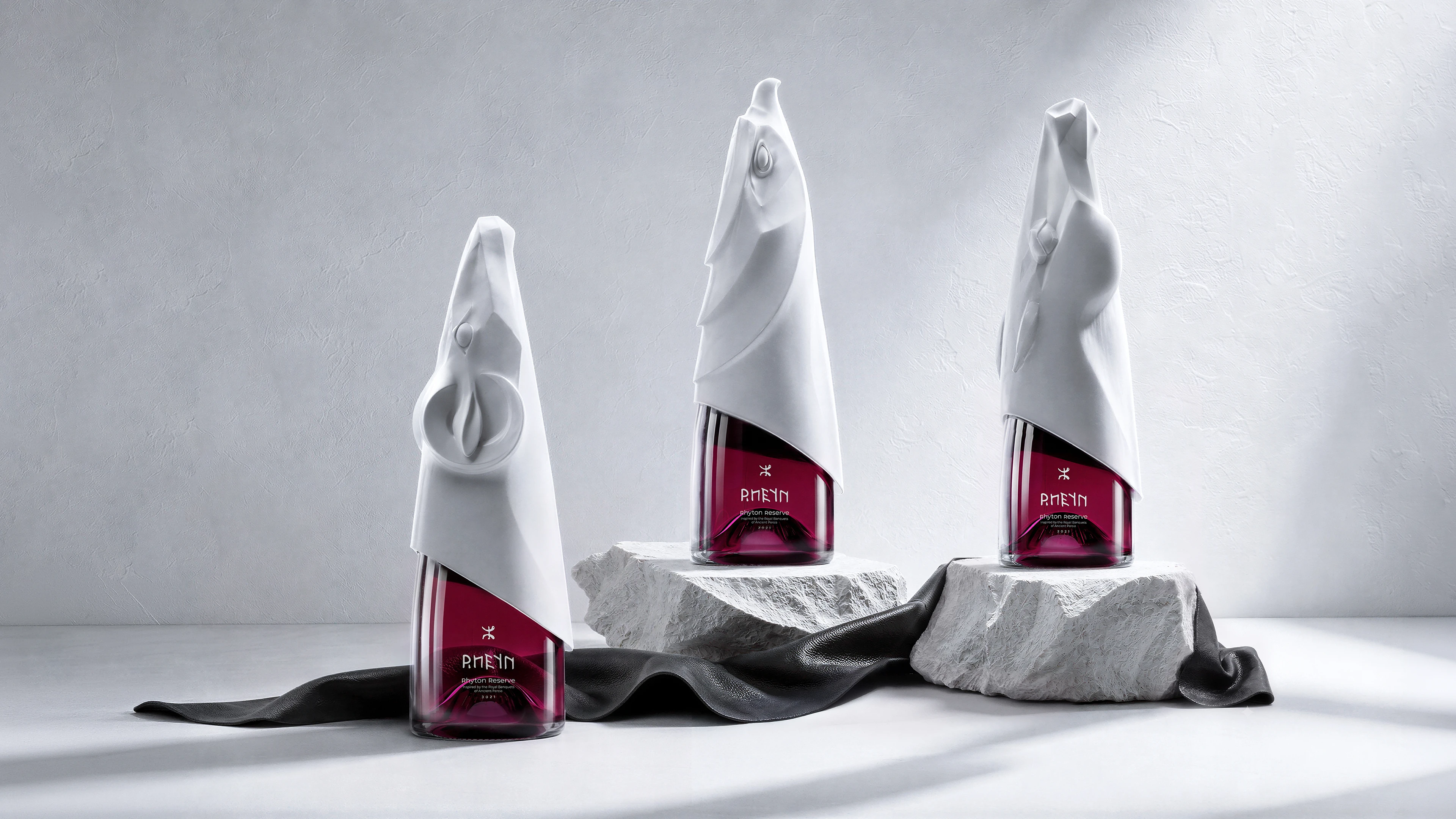 Three RHEYN Rhyton Reserve bottles showcasing DEEEZ’s sculptural beverage packaging design.